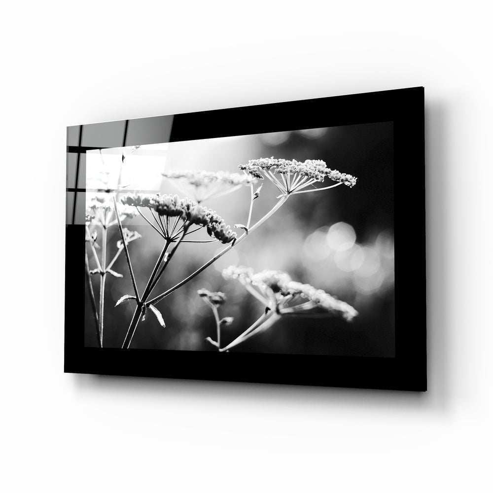 Bloom glass wall art displayed above a bed in a bedroom