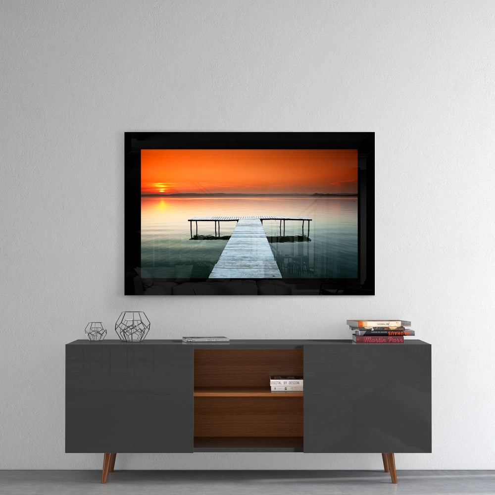 Sunset glass wall art styled above a console in a meditation room