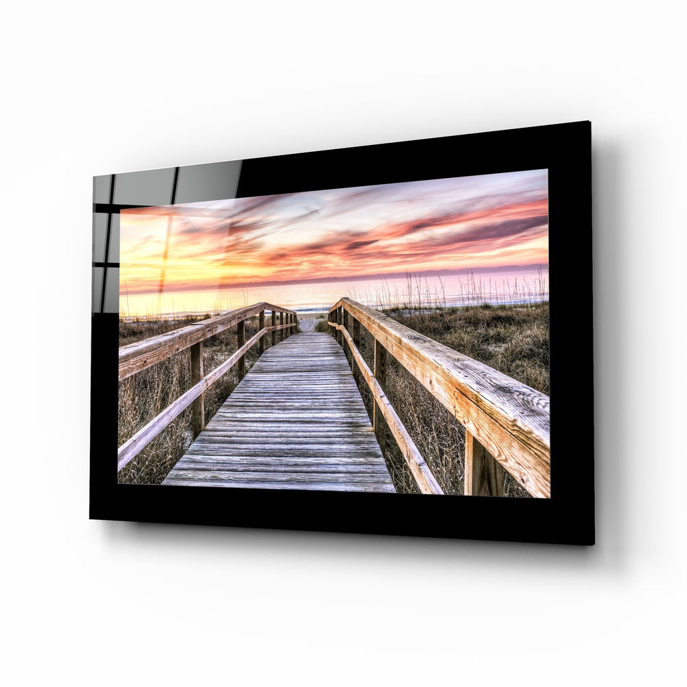 Sunset glass wall art displayed above a bed in a bedroom