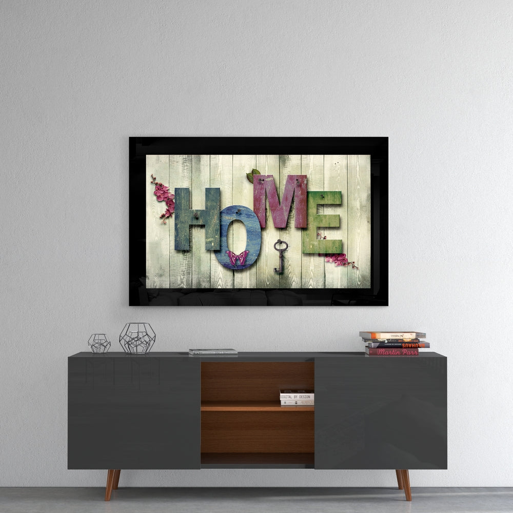 Home glass wall art styled above a sideboard in a reading nook