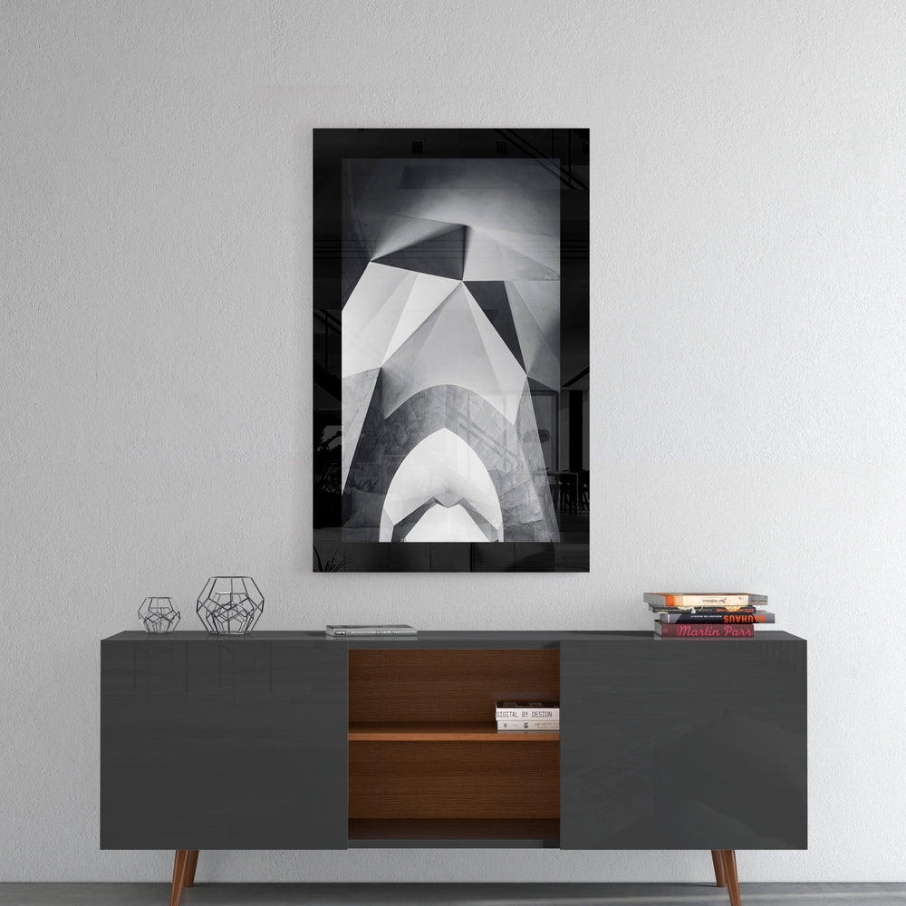 Gate glass wall art styled above a sideboard in a foyer