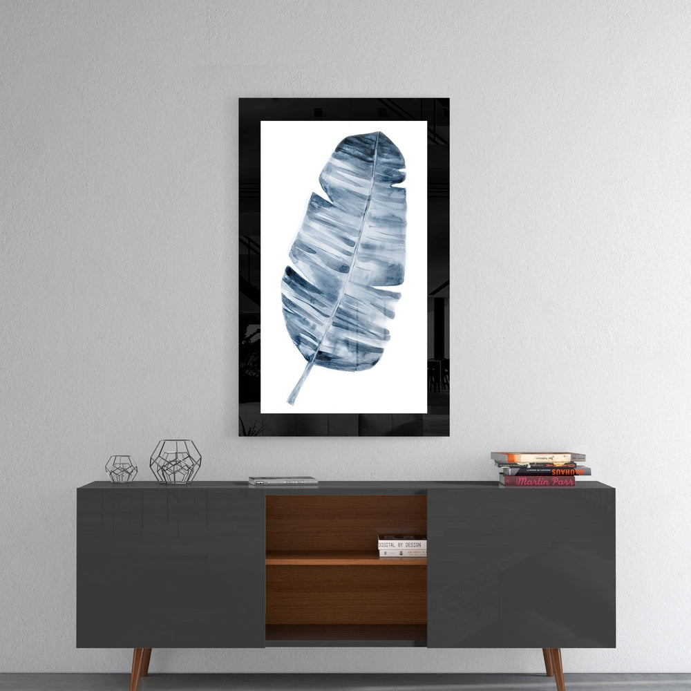 Leaf glass wall art styled above a console in a reading nook