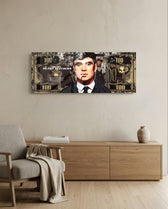 A gold-toned hundred-dollar note styled as a cinematic collage, with a front-facing portrait of a blue-eyed 1920s gangster in a pinstripe suit smoking a cigarette amid drifting smoke. panoramic glass wall art A