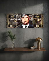 A gold-toned hundred-dollar note styled as a cinematic collage, with a front-facing portrait of a blue-eyed 1920s gangster in a pinstripe suit smoking a cigarette amid drifting smoke. panoramic glass wall art D