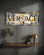 A hundred-dollar note reworked with bold black display lettering over a gold baroque pattern, with two flirtatious cartoon rabbits posed at the center amid yellow paint splashes. panoramic glass wall art D