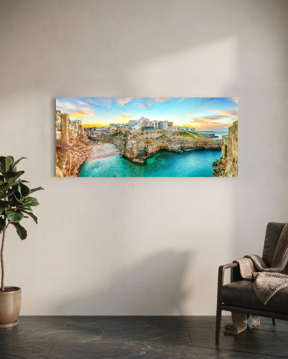 A cliffside Mediterranean town glowing at sunset above a turquoise cove. panoramic glass wall art C