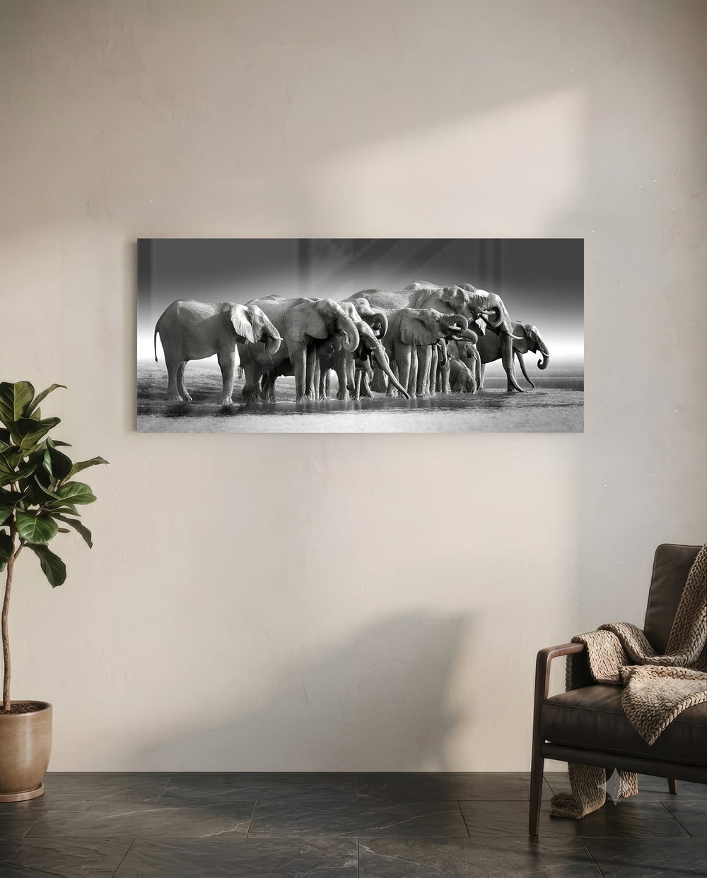 A herd of African elephants gathered at a waterline in soft black and white. panoramic glass wall art C