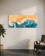A top-down aerial view of turquoise waves rolling in white foam onto golden sand. panoramic glass wall art C