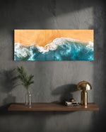 A top-down aerial view of turquoise waves rolling in white foam onto golden sand. panoramic glass wall art D