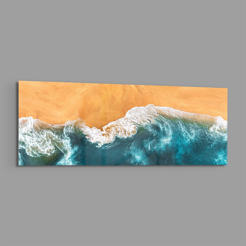 A top-down aerial view of turquoise waves rolling in white foam onto golden sand. panoramic glass wall art E