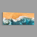 A top-down aerial view of turquoise waves rolling in white foam onto golden sand. panoramic glass wall art E