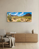 Sun-drenched Sonoran desert panorama with towering saguaro cacti, scrub and rugged mountains under a bright blue sky dotted with puffy clouds. panoramic glass wall art A