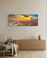 Aerial panoramic view of Venice at sunset, a great domed basilica and terracotta rooftops glowing beneath a fiery orange and blue sky over the lagoon. panoramic glass wall art A