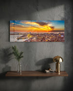 Aerial panoramic view of Venice at sunset, a great domed basilica and terracotta rooftops glowing beneath a fiery orange and blue sky over the lagoon. panoramic glass wall art D