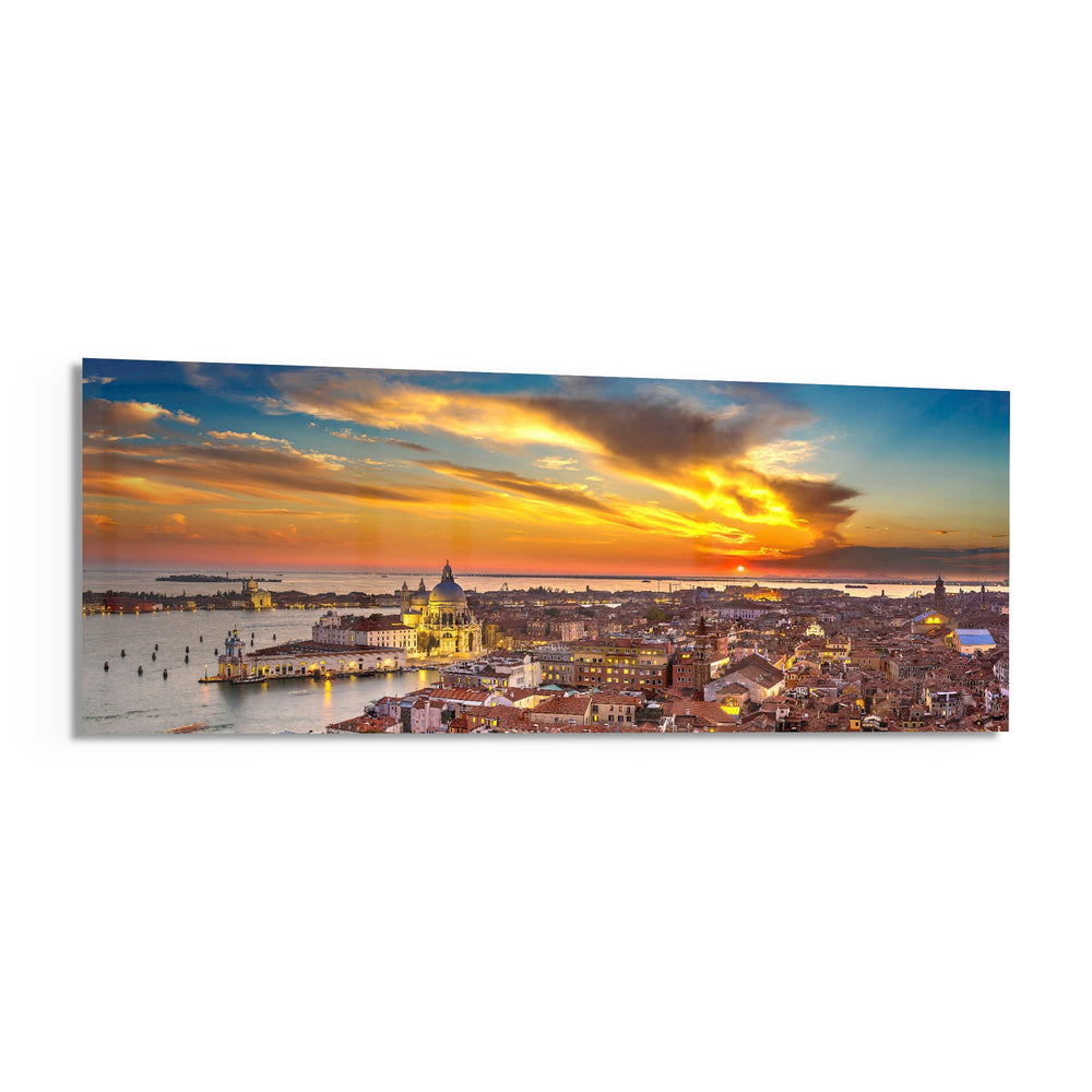 Aerial panoramic view of Venice at sunset, a great domed basilica and terracotta rooftops glowing beneath a fiery orange and blue sky over the lagoon. panoramic glass wall art F