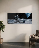 A spacesuited astronaut lounging in a deck chair on the lunar surface while planet Earth hangs in the black sky. panoramic glass wall art C