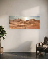 Rolling golden sand dunes rippling toward the horizon under a soft, hazy sun low in a pale sky. panoramic glass wall art C