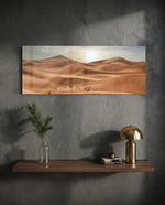 Rolling golden sand dunes rippling toward the horizon under a soft, hazy sun low in a pale sky. panoramic glass wall art D
