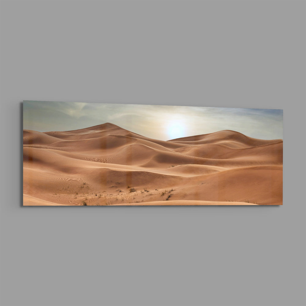Rolling golden sand dunes rippling toward the horizon under a soft, hazy sun low in a pale sky. panoramic glass wall art E