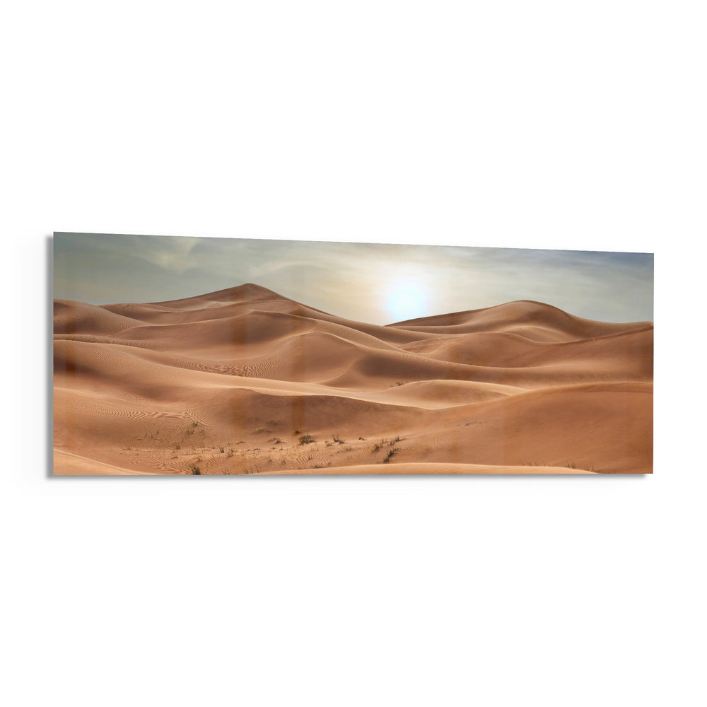 Rolling golden sand dunes rippling toward the horizon under a soft, hazy sun low in a pale sky. panoramic glass wall art F