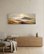 A rugged range of ochre and red-brown mountains and hills wrapped in drifting fog beneath a pale rising sun. panoramic glass wall art A