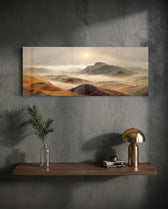 A rugged range of ochre and red-brown mountains and hills wrapped in drifting fog beneath a pale rising sun. panoramic glass wall art D