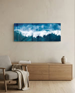A powerful blue ocean wave breaking into white foam and spray across a wide panoramic seascape. panoramic glass wall art A