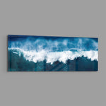 A powerful blue ocean wave breaking into white foam and spray across a wide panoramic seascape. panoramic glass wall art E