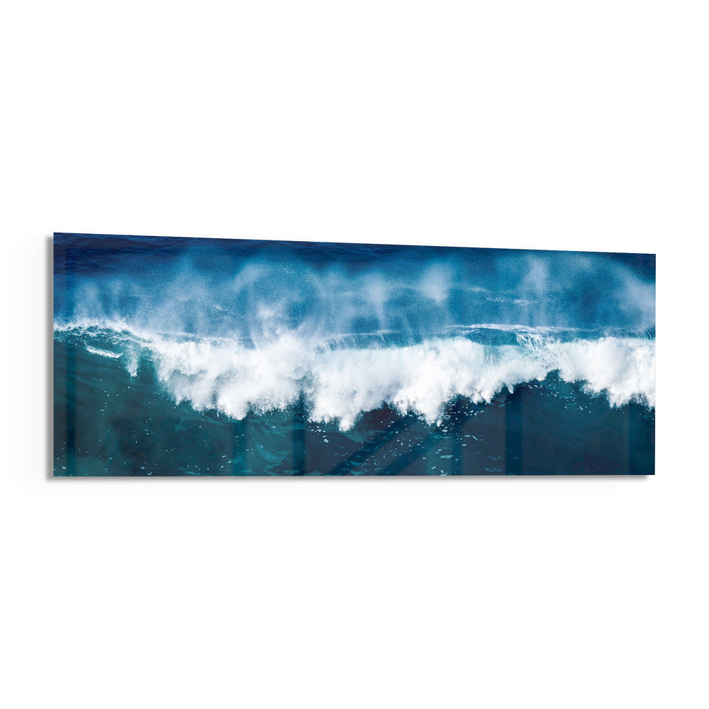 A powerful blue ocean wave breaking into white foam and spray across a wide panoramic seascape. panoramic glass wall art F