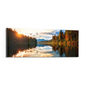 A mirror-calm lake at sunrise reflecting autumn forest, distant mountains, and a glowing cloudy sky. panoramic glass wall art F