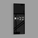 Minimalist black typography panel where the words "RISK" and "RICH" interlock in a single vertical column of white letters. panoramic glass wall art E