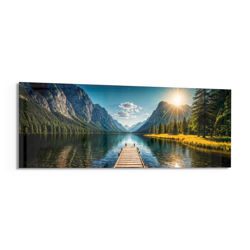 Panoramic alpine landscape of a mirror-calm lake with a wooden dock leading toward sunlit mountains and pine forest. panoramic glass wall art F
