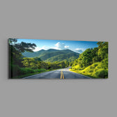 Panoramic view of an empty asphalt road curving through lush green tropical mountains under a bright blue sky. panoramic glass wall art E