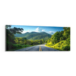 Panoramic view of an empty asphalt road curving through lush green tropical mountains under a bright blue sky. panoramic glass wall art F