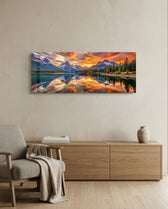 Snow-capped mountain peaks mirrored in a still alpine lake beneath a blazing golden sunset. panoramic glass wall art A