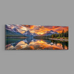 Snow-capped mountain peaks mirrored in a still alpine lake beneath a blazing golden sunset. panoramic glass wall art E