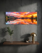 A blazing pink and orange sunset sky mirrored on a perfectly still forest lake. panoramic glass wall art D
