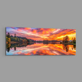 A blazing pink and orange sunset sky mirrored on a perfectly still forest lake. panoramic glass wall art E