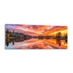 A blazing pink and orange sunset sky mirrored on a perfectly still forest lake. panoramic glass wall art F