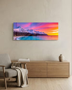 Snow-capped mountains under a vivid pink and orange twilight sky above a turquoise curving shoreline. panoramic glass wall art A