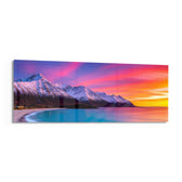 Snow-capped mountains under a vivid pink and orange twilight sky above a turquoise curving shoreline. panoramic glass wall art F