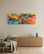 An explosive abstract of poured and splattered rainbow paint in rich, glossy colour. panoramic glass wall art A