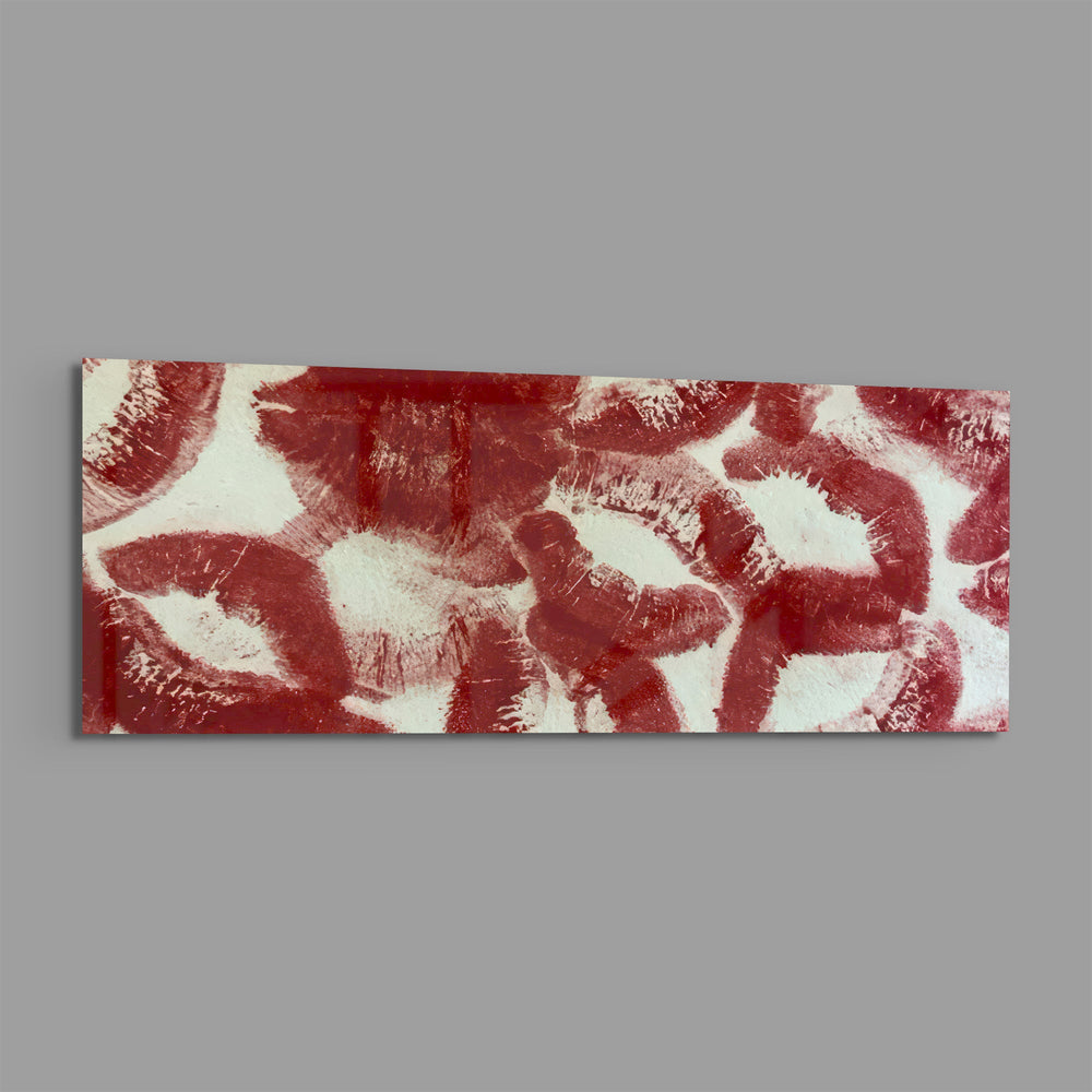 A scattered pattern of deep red lipstick kiss prints stamped across a creamy white surface panoramic glass wall art E