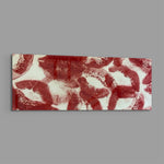 A scattered pattern of deep red lipstick kiss prints stamped across a creamy white surface panoramic glass wall art E