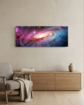 A glowing spiral galaxy swirling through clouds of pink, purple and blue across a star-filled cosmos. panoramic glass wall art A
