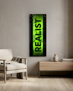The single bold word "REALIST" in black over a distressed toxic-green stripe framed by black borders. panoramic glass wall art F