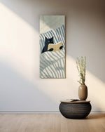 Minimalist illustration of a black cat propped up in striped bedding holding an open book. panoramic glass wall art A