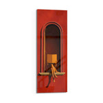 A seated figure reading on the sill of a terracotta-red arched niche, face hidden behind an open golden book. panoramic glass wall art D