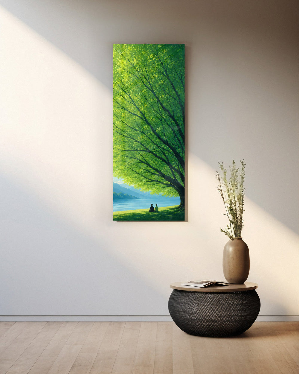 Two small figures sitting together on grass beneath a vast green tree, gazing over a calm blue lake toward distant mountains. panoramic glass wall art A