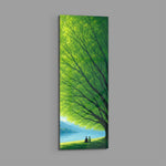 Two small figures sitting together on grass beneath a vast green tree, gazing over a calm blue lake toward distant mountains. panoramic glass wall art E